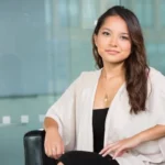 Young Asian woman posing while sitting