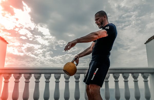 Young Man Engaged in High Intensity Kettlebell Workout