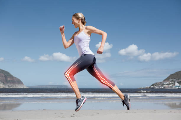 Young woman running in the beach illustrating healthy joints