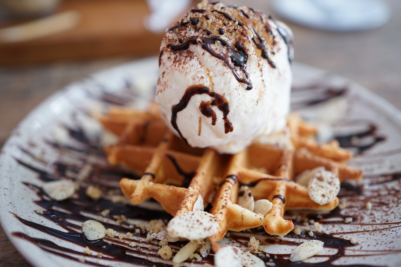 Image of waffle, candy, and ice cream illustrating the challenge of being addicted to sugar and how to stop these cravings.