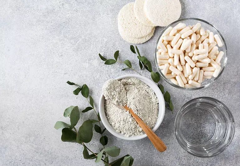 Collagen powder in a cup with collagen capsules beside it, promoting skin, hair, nail, and joint health. High-quality collagen supplements for daily wellness.